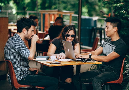 Image: Students studying together at a cafe.
